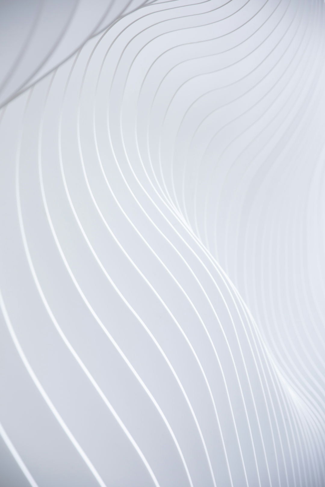 a-close-up-of-a-white-wall-with-wavy-lines.jpg a close up of a white wall with wavy lines