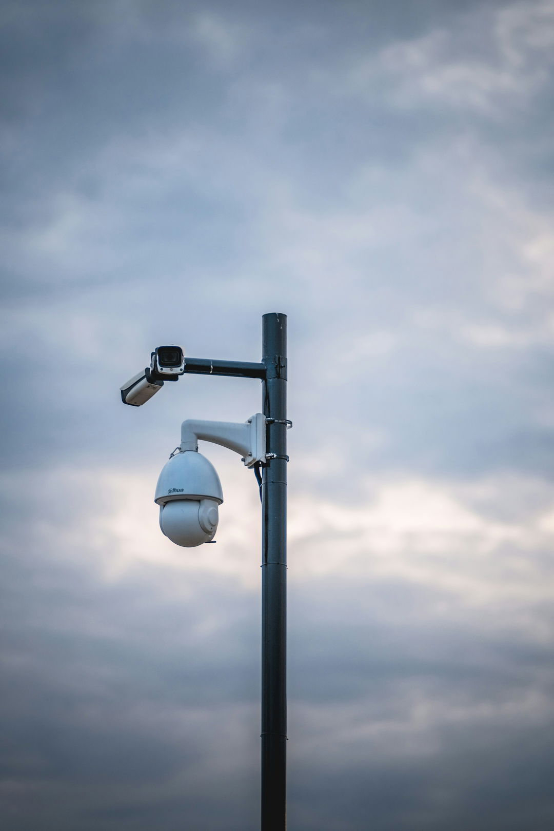 a-street-light-with-a-camera-attached-to-it.jpg a street light with a camera attached to it